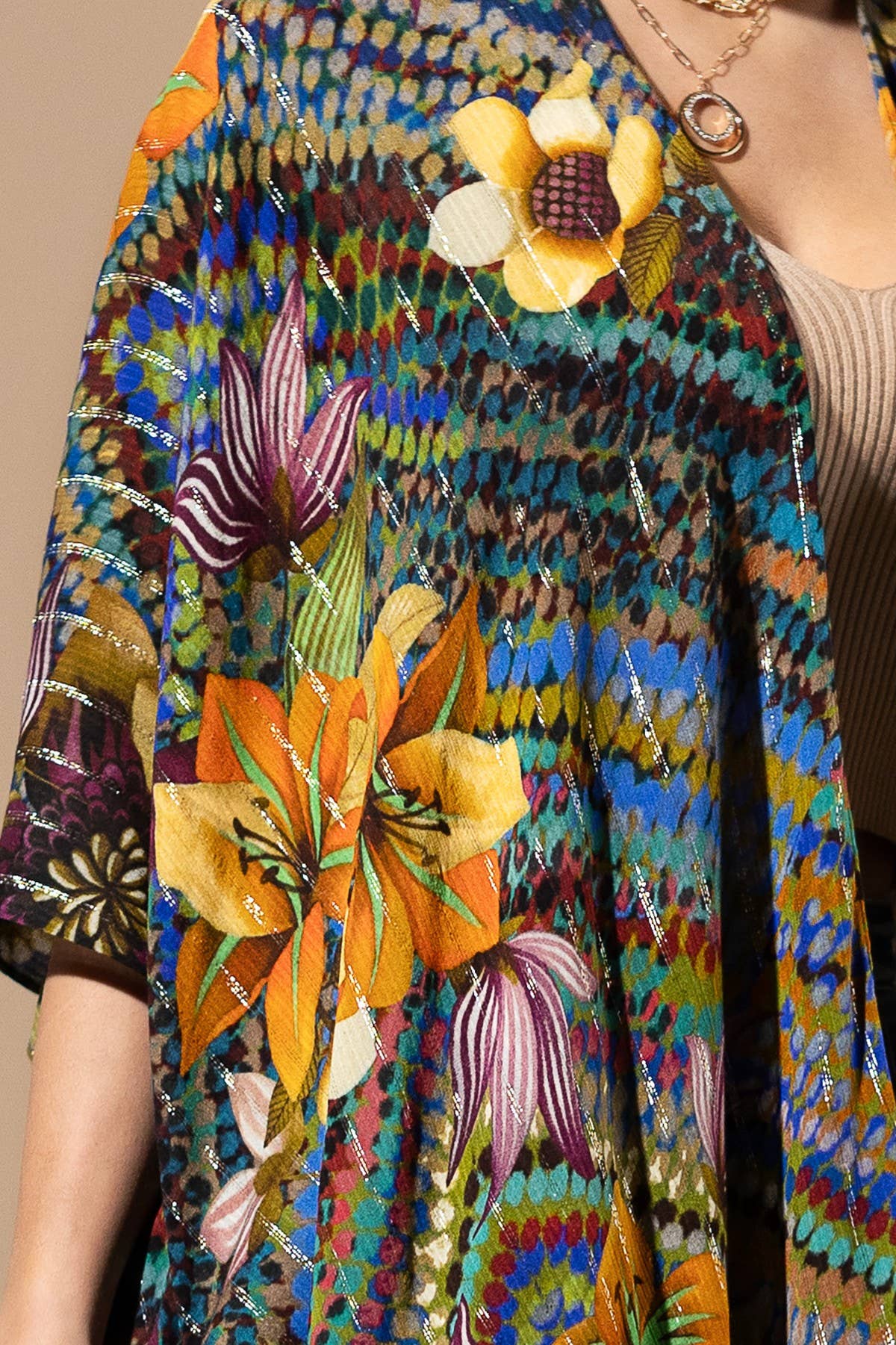 Colorful patterned scarf with floral designs worn by a person