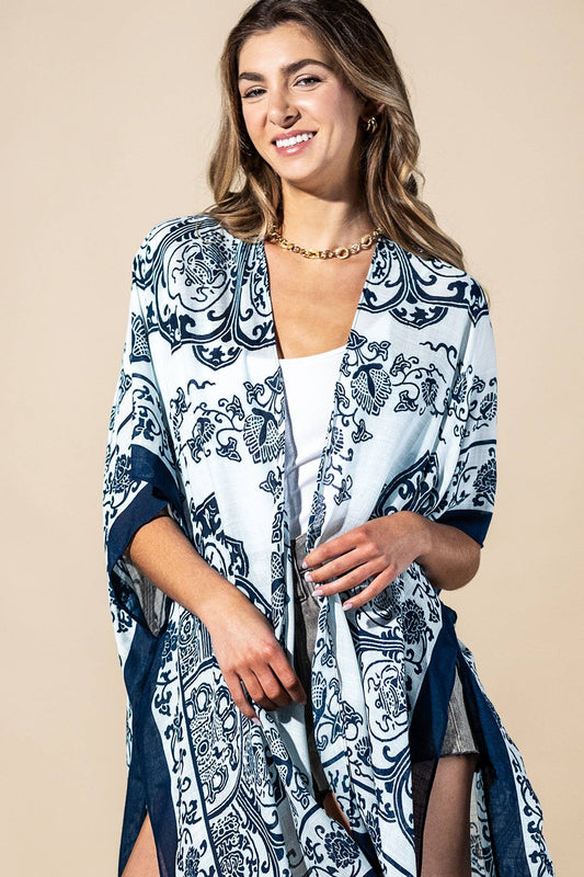 Woman wearing a blue and white patterned kimono over a white top on a beige background