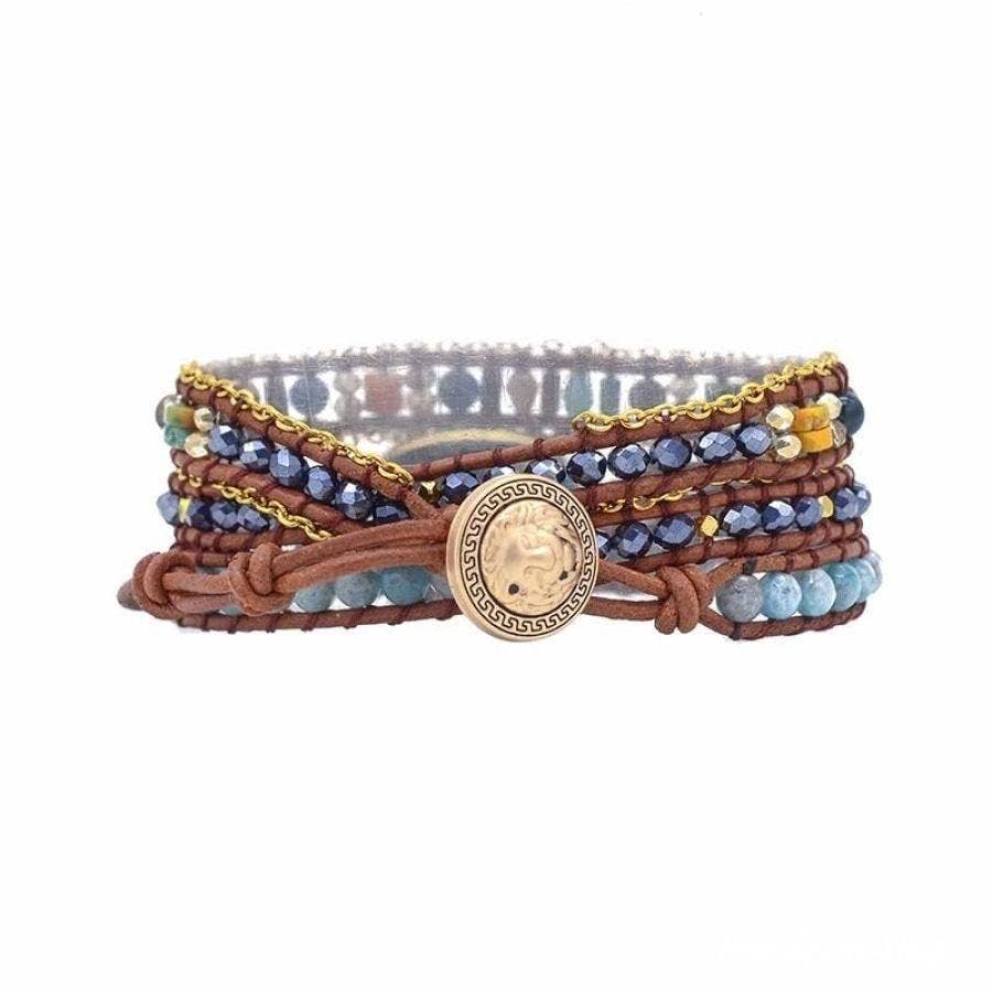 Multistrand bracelet with beads and a gold coin charm on a white background