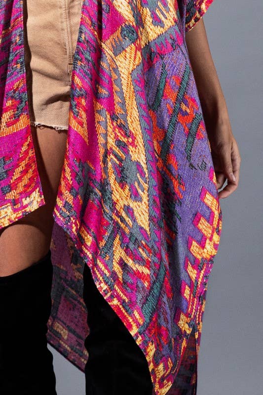 Colorful patterned garment worn by a person on a gray background
