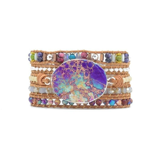 Multicolored beaded bracelet with a large round stone on a white background
