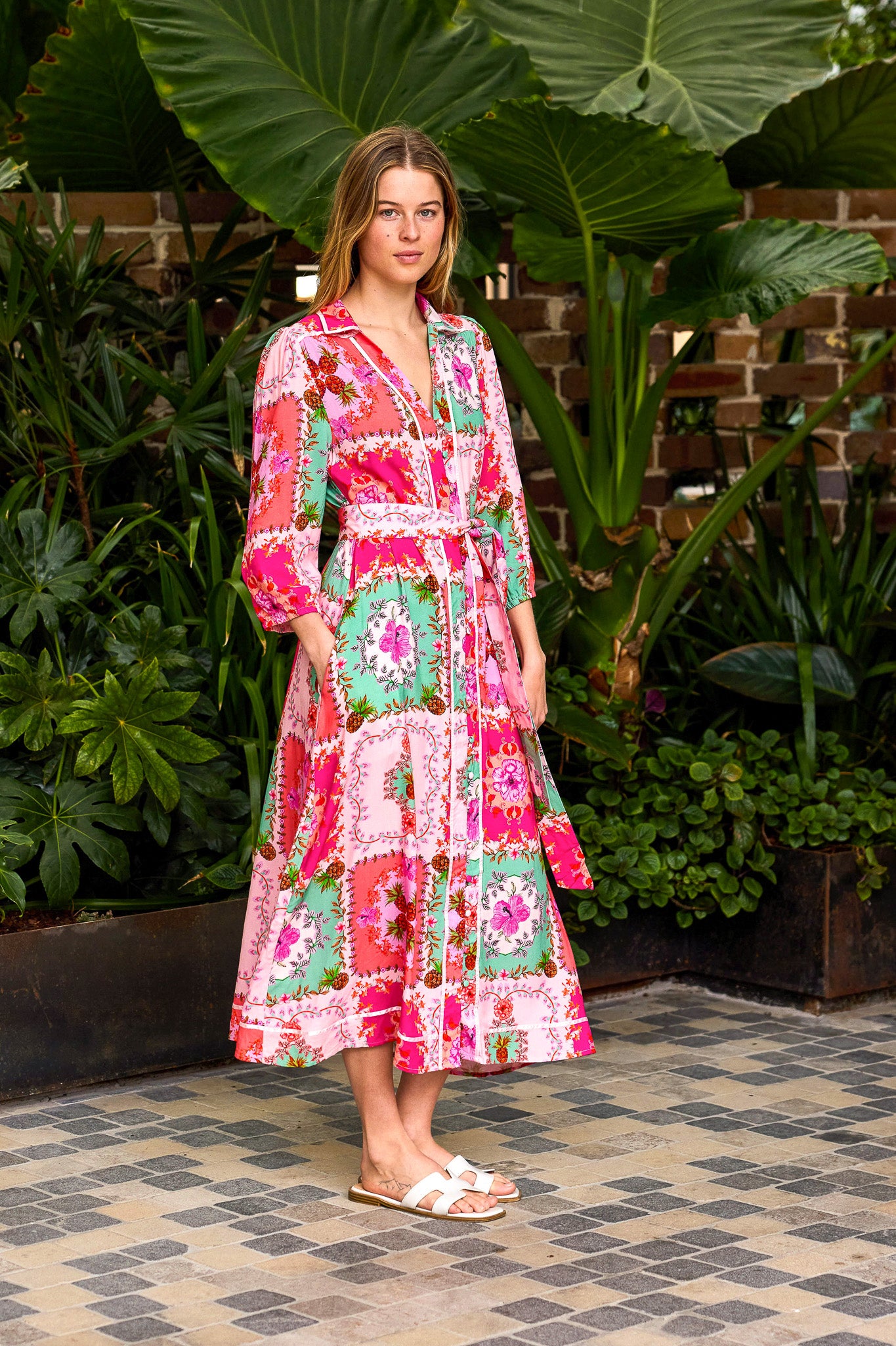 Woman in a colorful dress standing in a garden setting