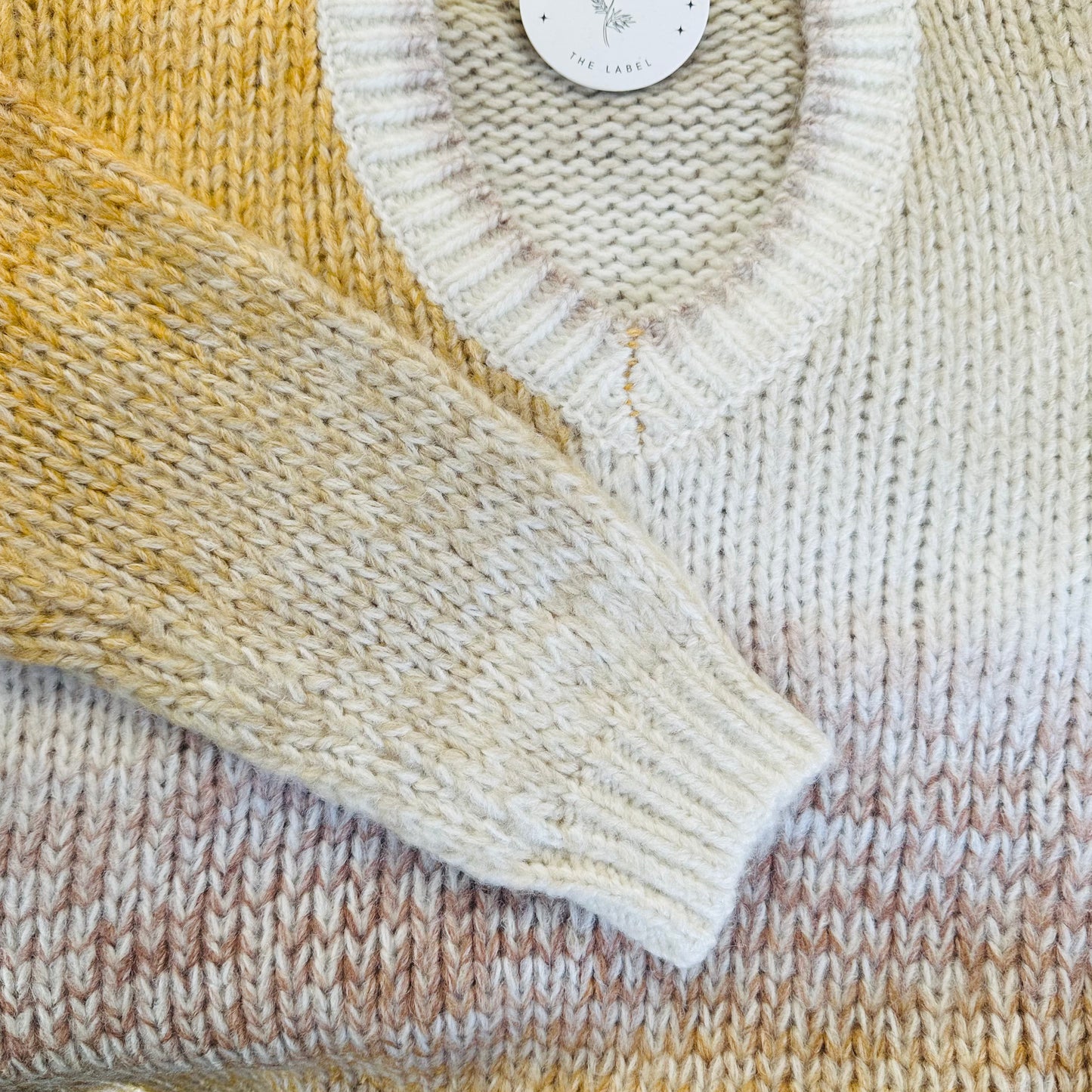 Close-up of a knitted fabric with a label in the top right corner.