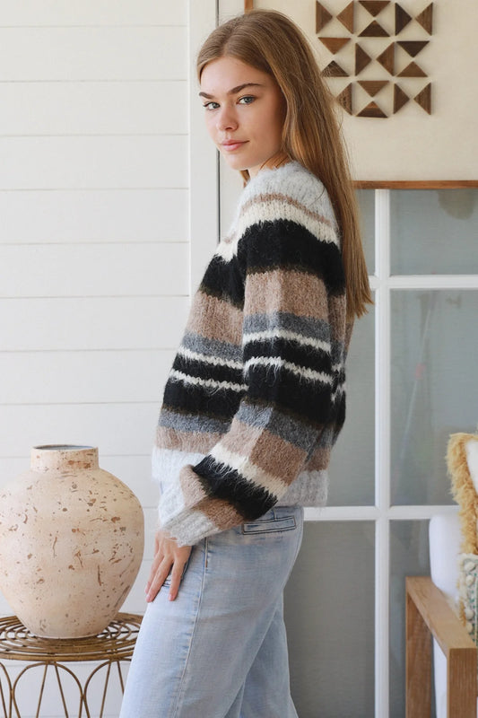 Woman wearing a striped sweater in a home setting