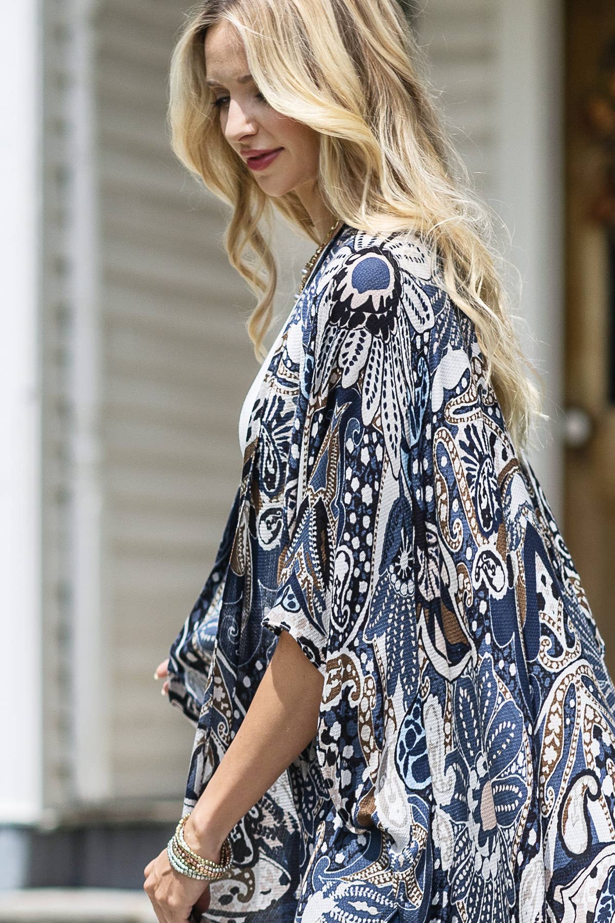 Woman wearing a blue and white patterned kimono-style garment.