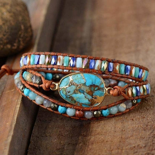 Multistrand bracelet with turquoise stone and beads on a wooden surface.