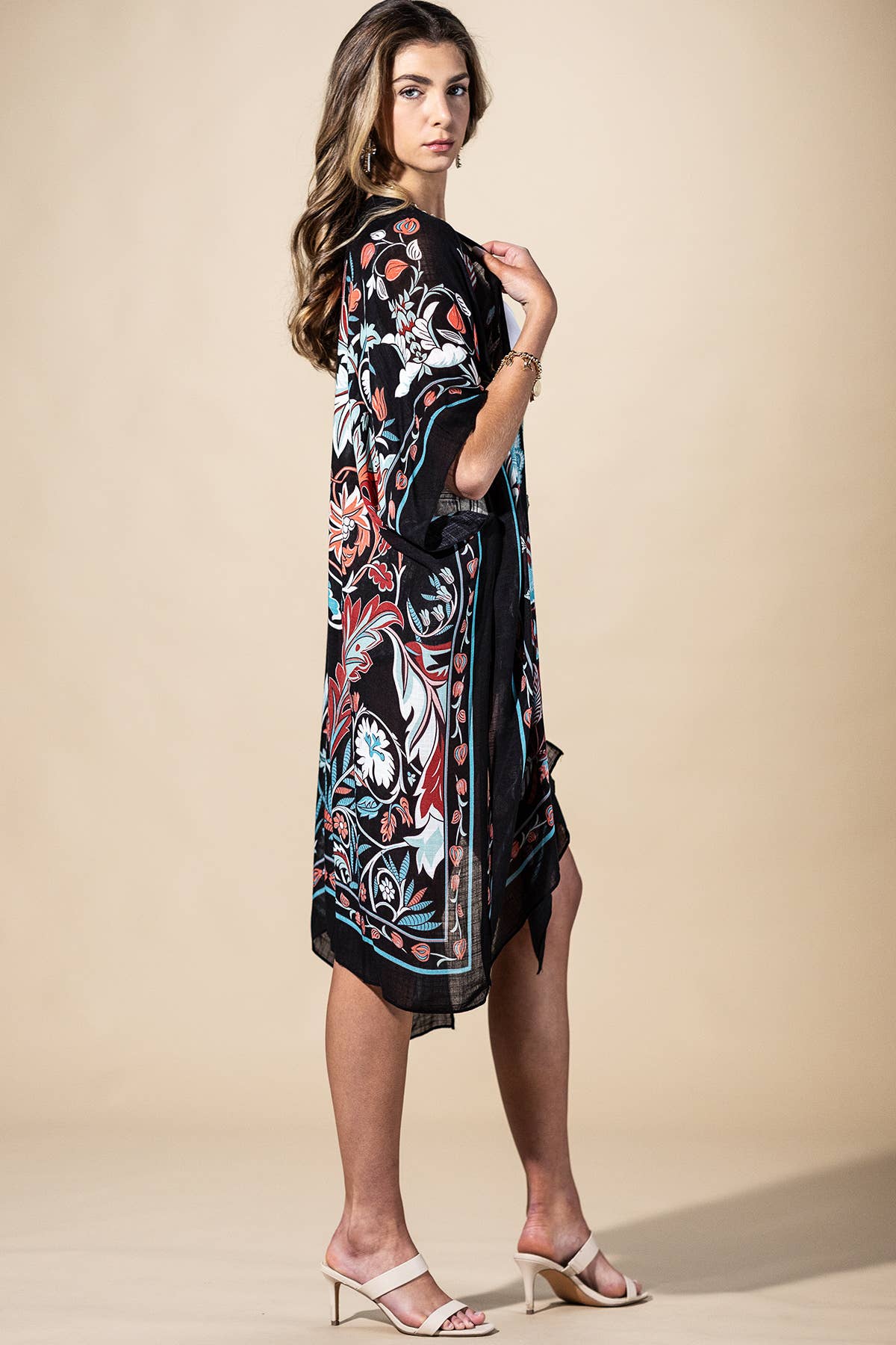 Woman wearing a floral dress with a beige background