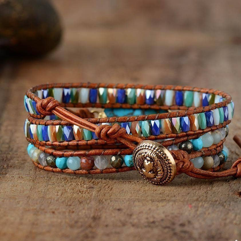 Multicolored beaded bracelet with a decorative button on a wooden surface.