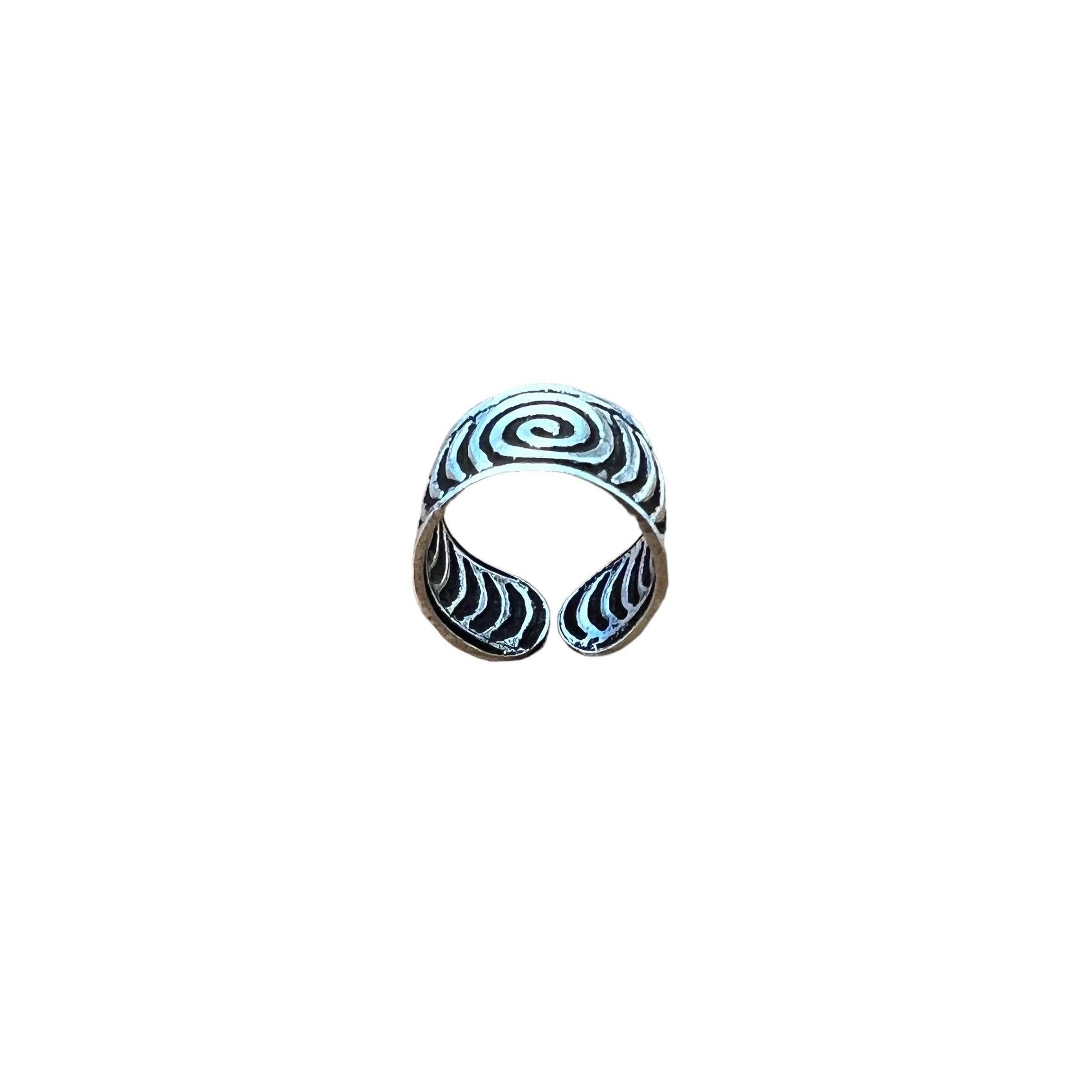 Crescent moon-shaped ring with black and white pattern on a white background