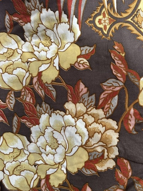 A close-up of a fabric or wallpaper pattern featuring large cream and pale yellow peony flowers with red and brown leaves on a dark charcoal background.