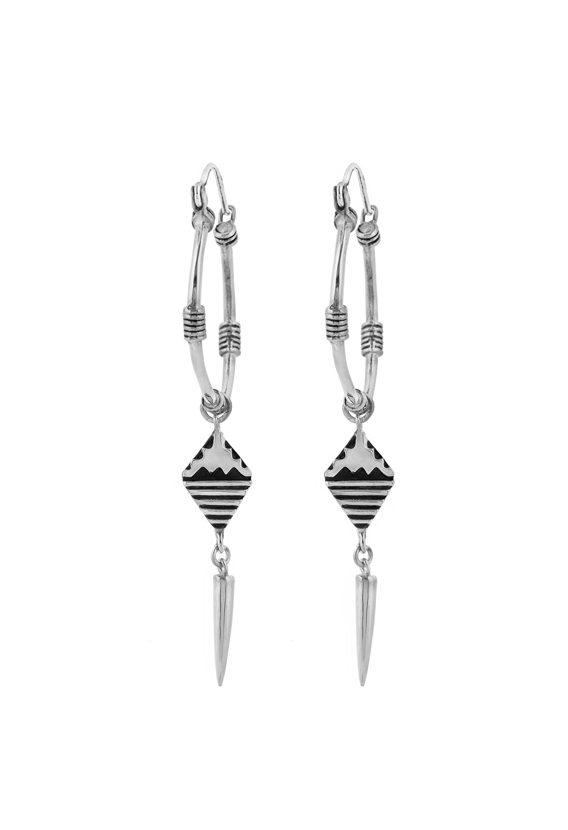 Pair of silver earrings with geometric designs on a white background