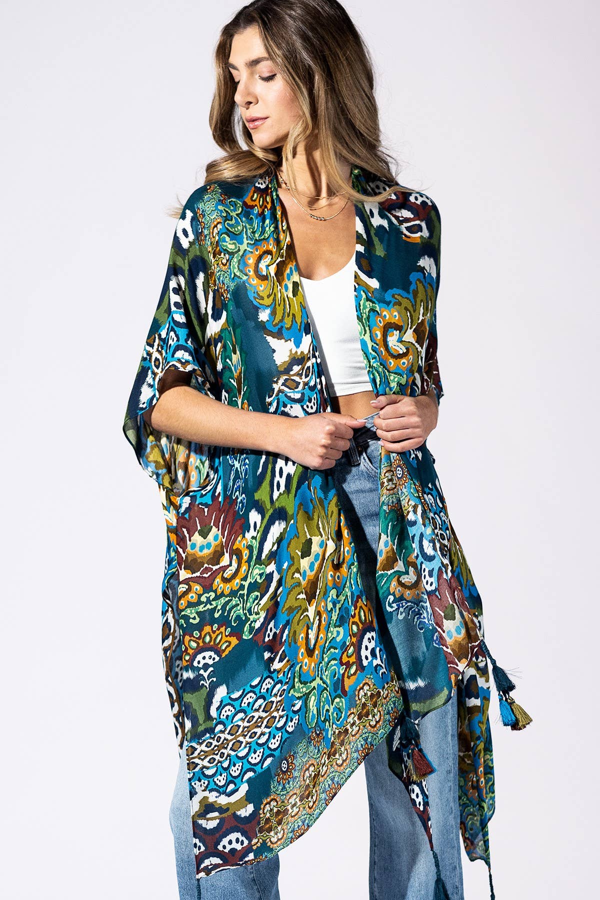 Woman wearing a colorful patterned kimono against a white background