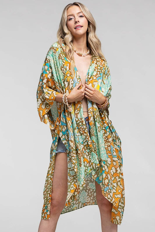 Woman wearing a floral kimono-style garment on a plain background