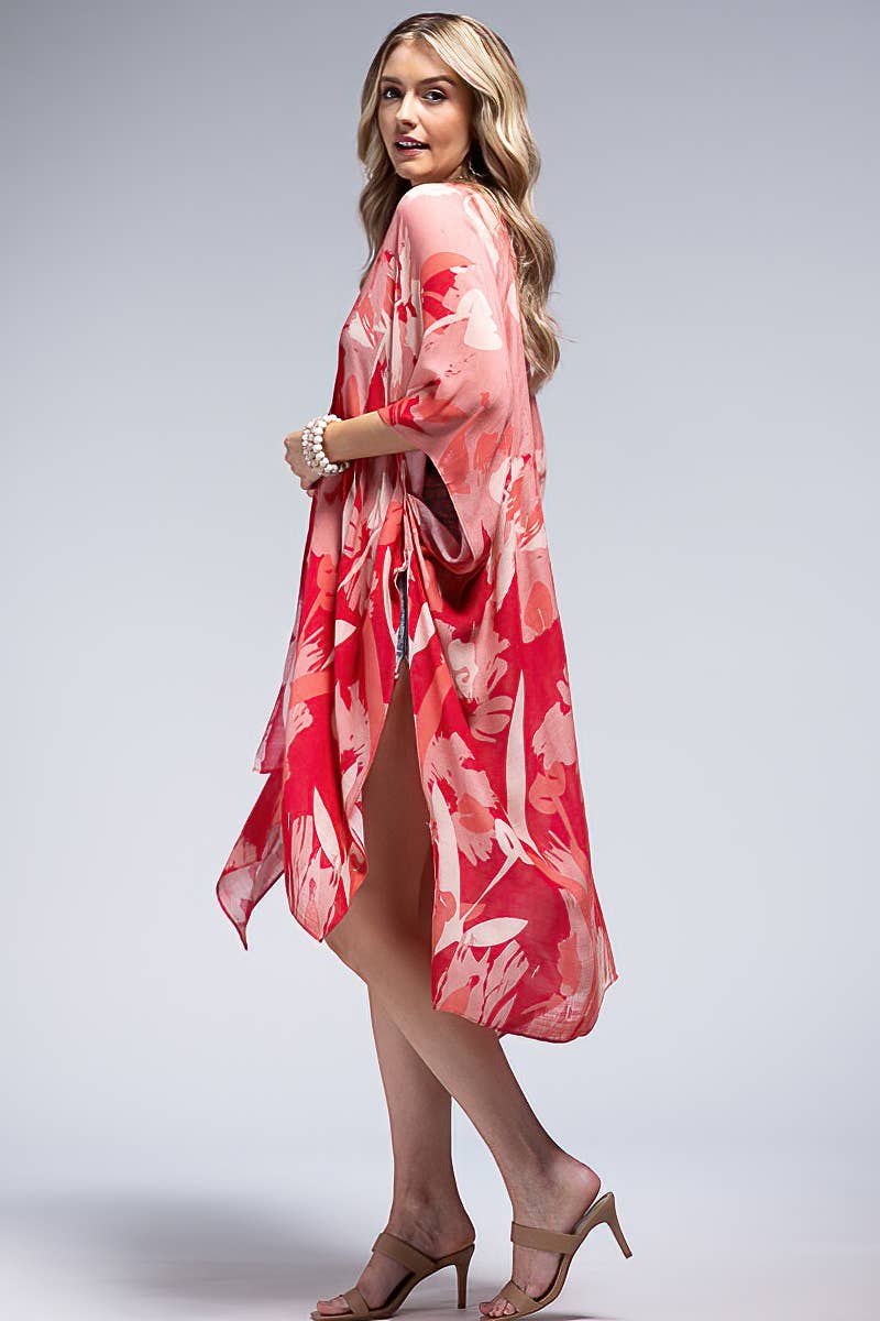 Woman wearing a red floral kimono on a gray background