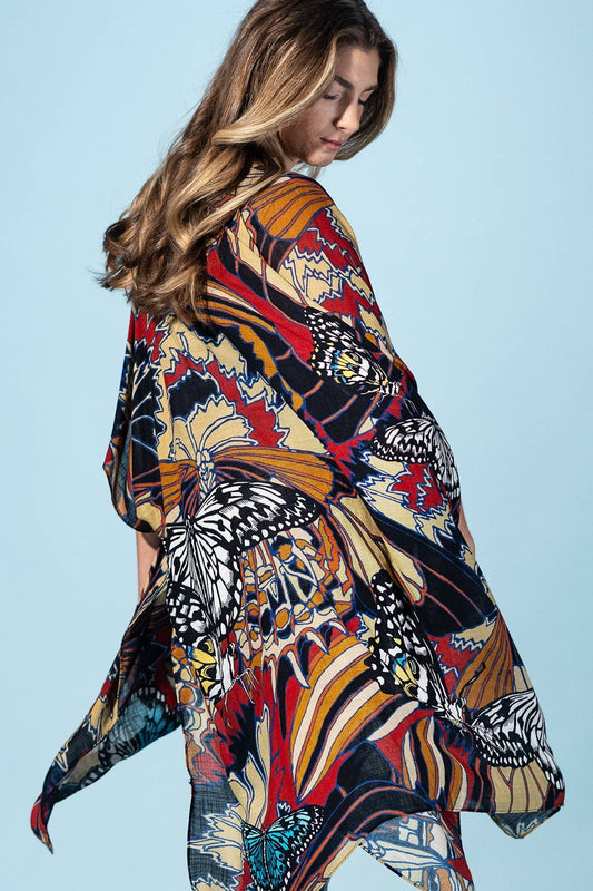 Woman wearing a colorful patterned kimono against a light blue background