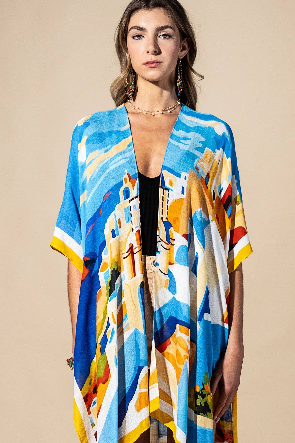 Woman wearing a colorful kimono-style garment on a beige background