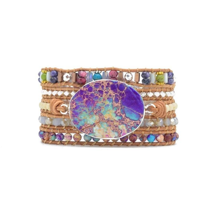 Multicolored beaded bracelet with a large round stone on a white background