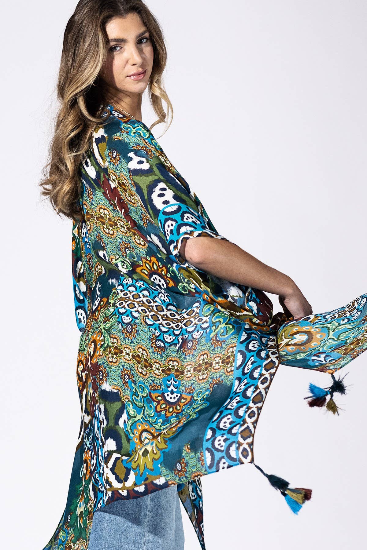 Woman wearing a colorful patterned scarf on a white background