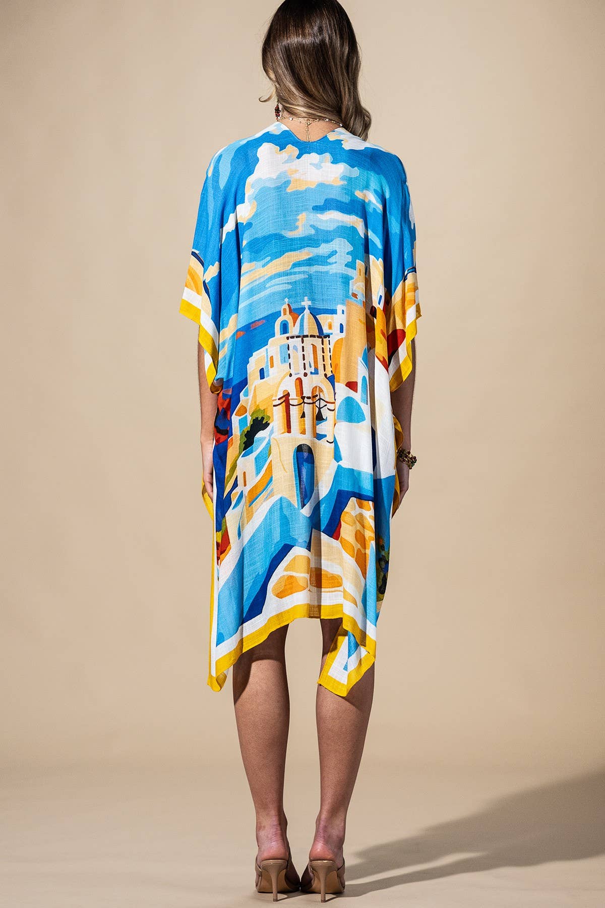 Woman wearing a colorful dress with a castle design on a beige background