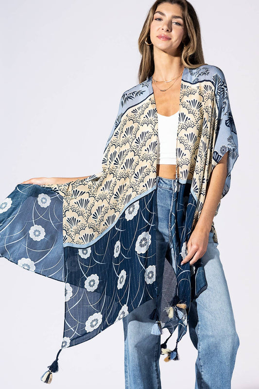 Woman wearing a floral kimono-style garment with a plain background