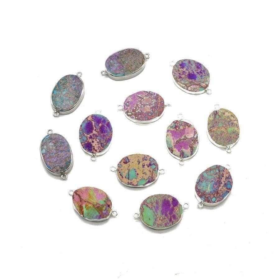 Multicolored druzy stone pendants with silver settings on a white background