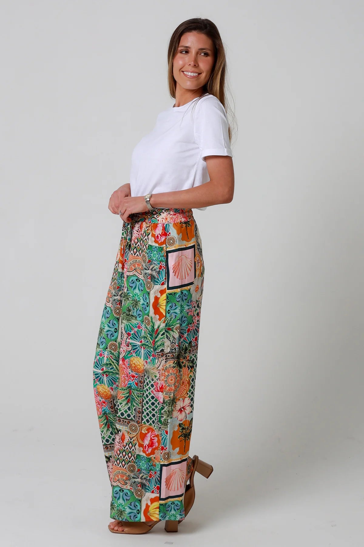 Woman wearing a colorful patchwork skirt on a plain background