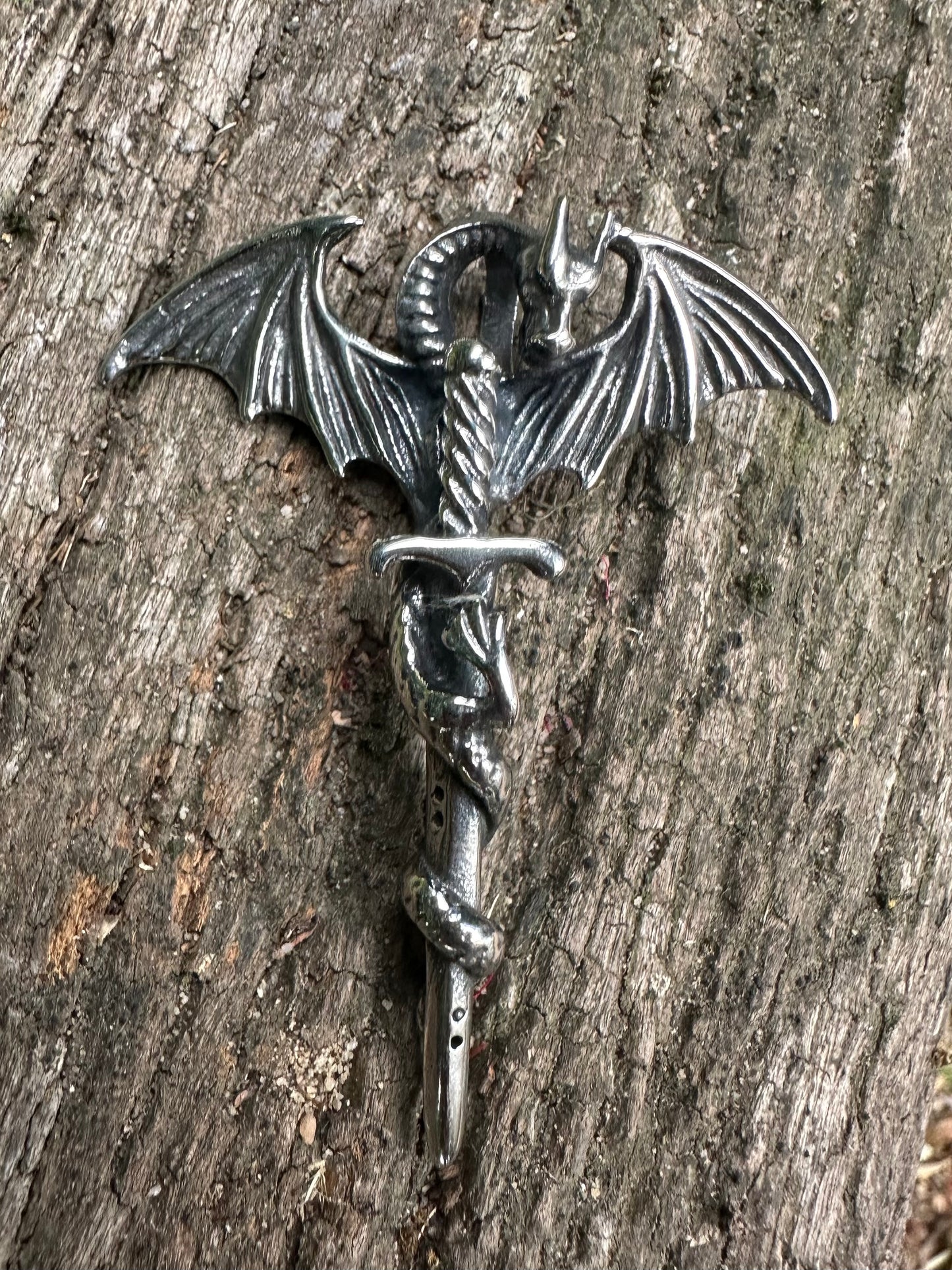 Metallic dragonfly figurine on a wooden surface