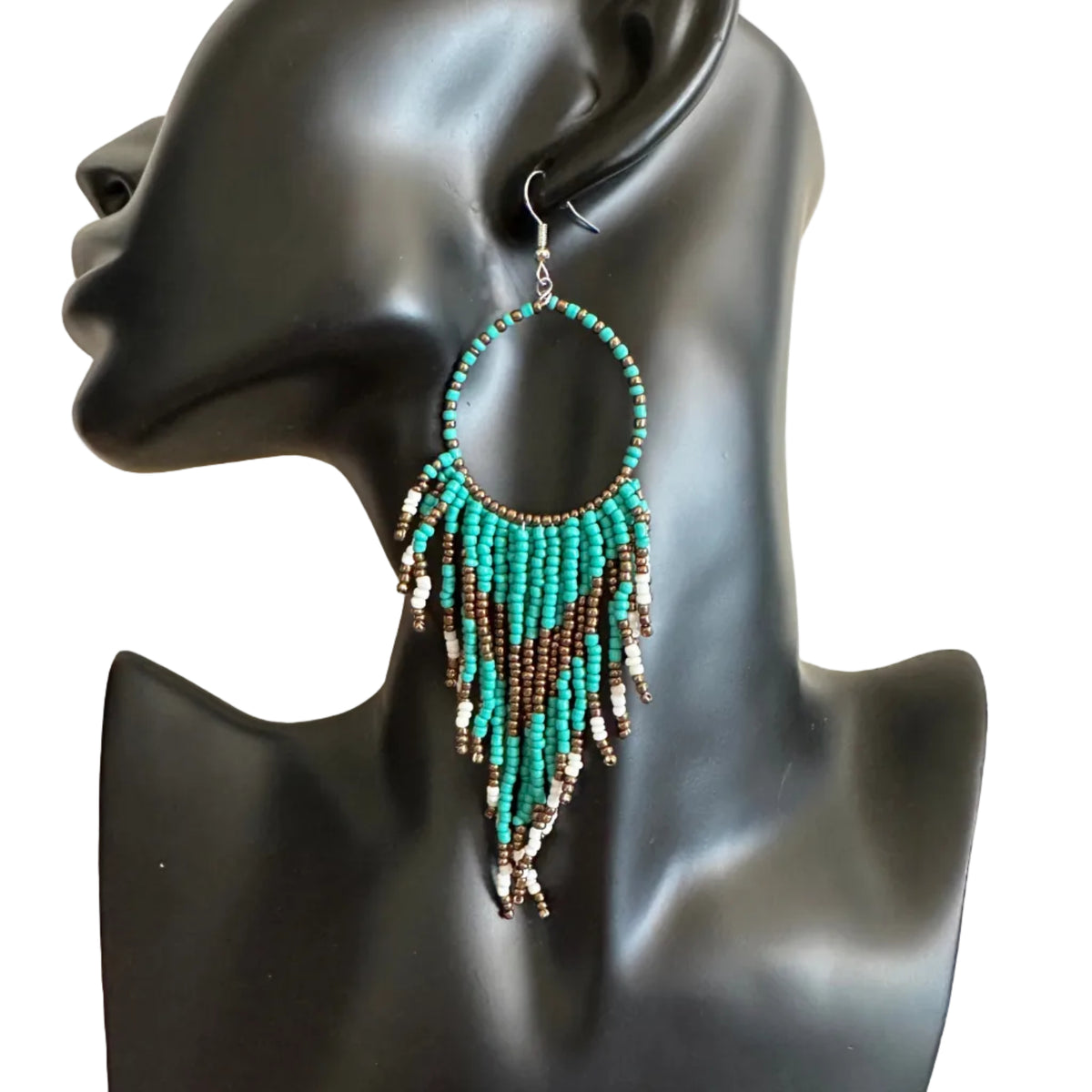 A pair of large, handmade beaded hoop earrings displayed on a black mannequin bust. The earrings feature a turquoise and brown beaded circular hoop with dangling fringe beads in turquoise, brown, and silver-toned metal.