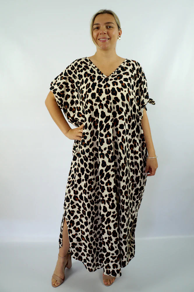Woman wearing a leopard print dress on a white background
