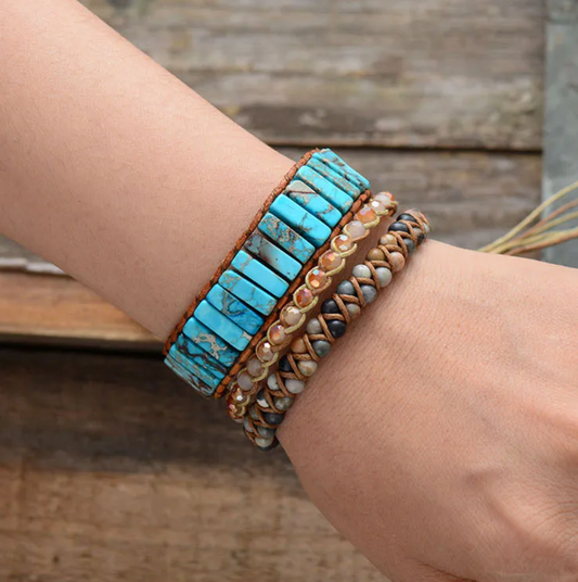 Turquoise beaded bracelet on a wrist with a wooden background