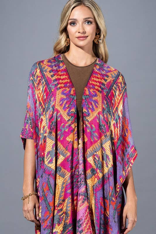 Woman wearing a colorful patterned kimono against a gray background