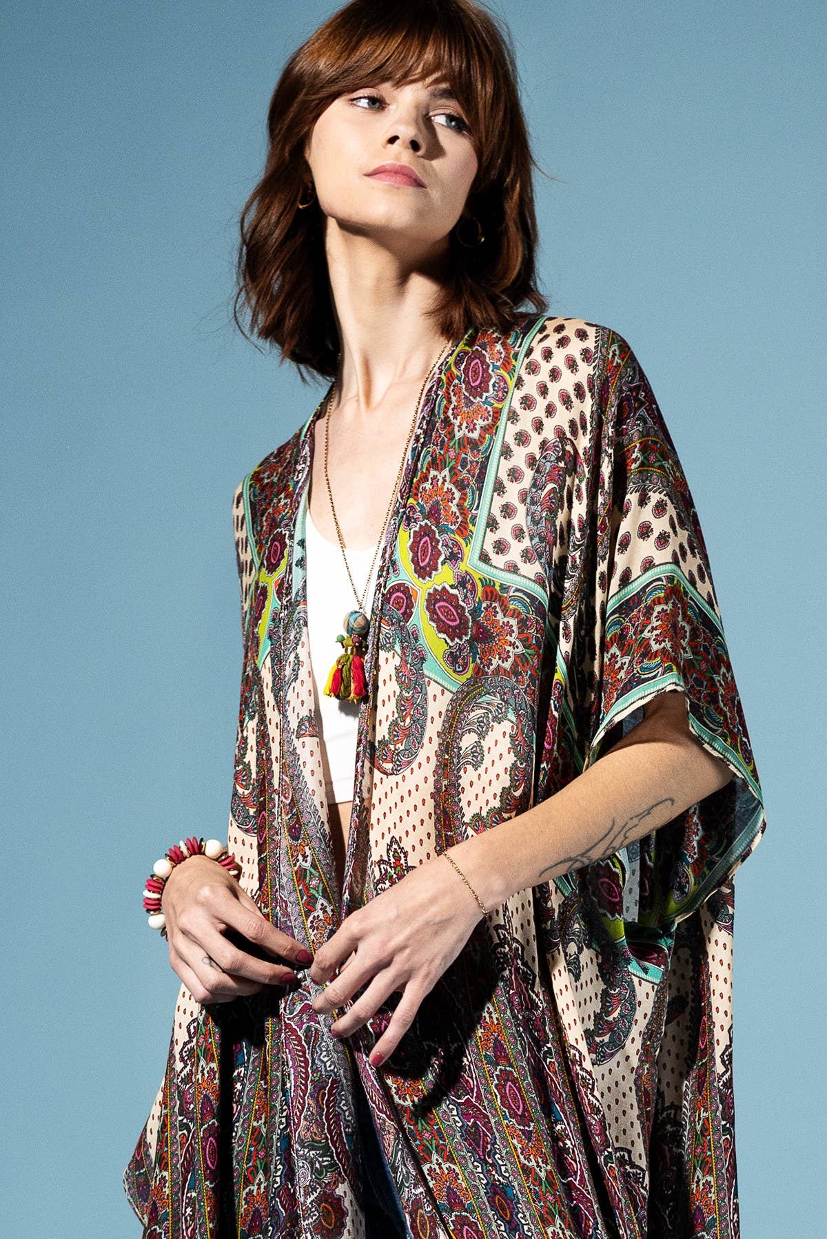 Woman wearing a patterned kimono against a blue background