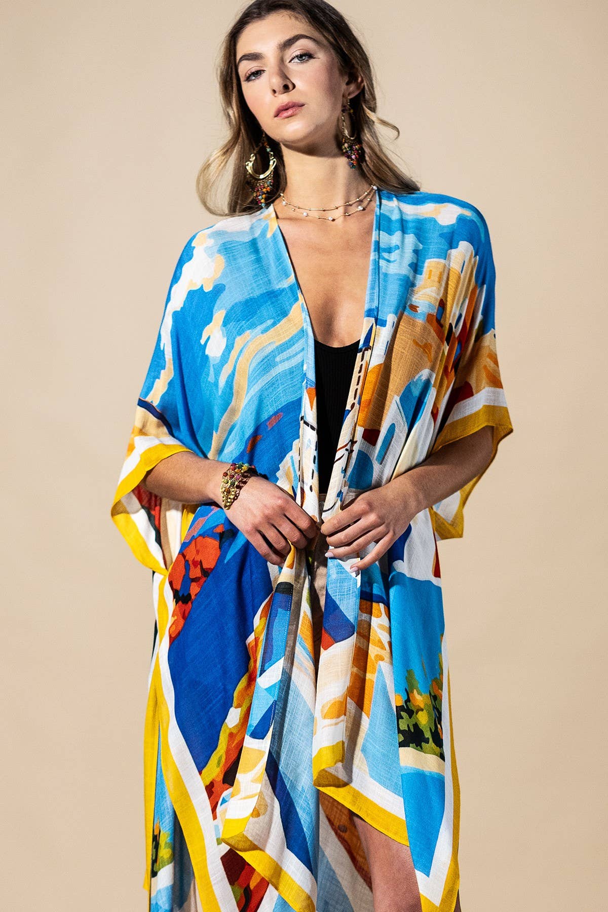 Woman wearing a colorful kimono-style garment against a beige background
