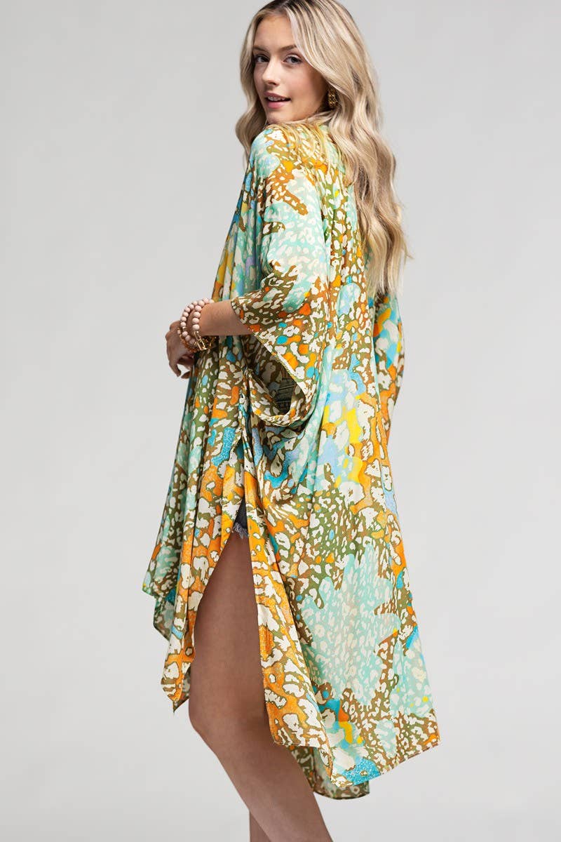 Woman wearing a colorful floral dress on a plain background