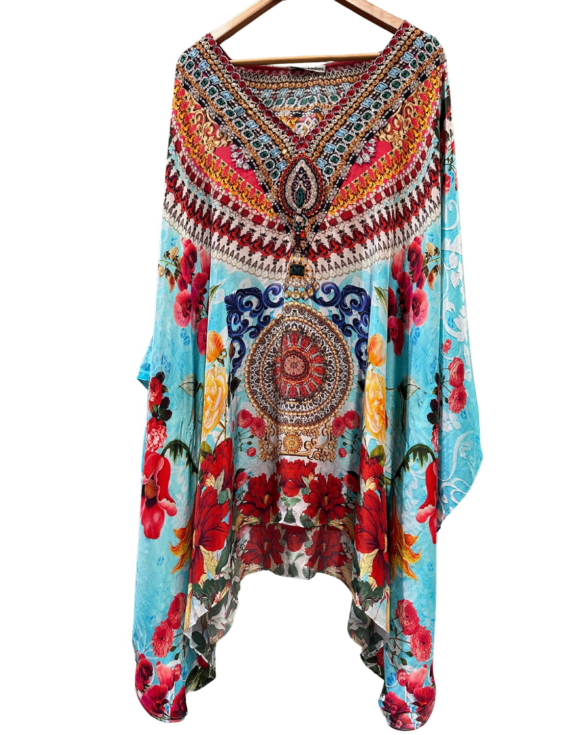 Colorful floral and patterned dress on a hanger against a white background