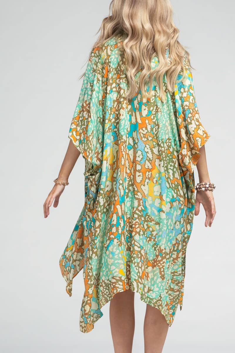 Woman wearing a floral patterned dress on a plain background