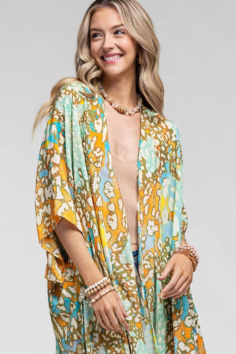 Woman wearing a colorful patterned kimono against a plain background