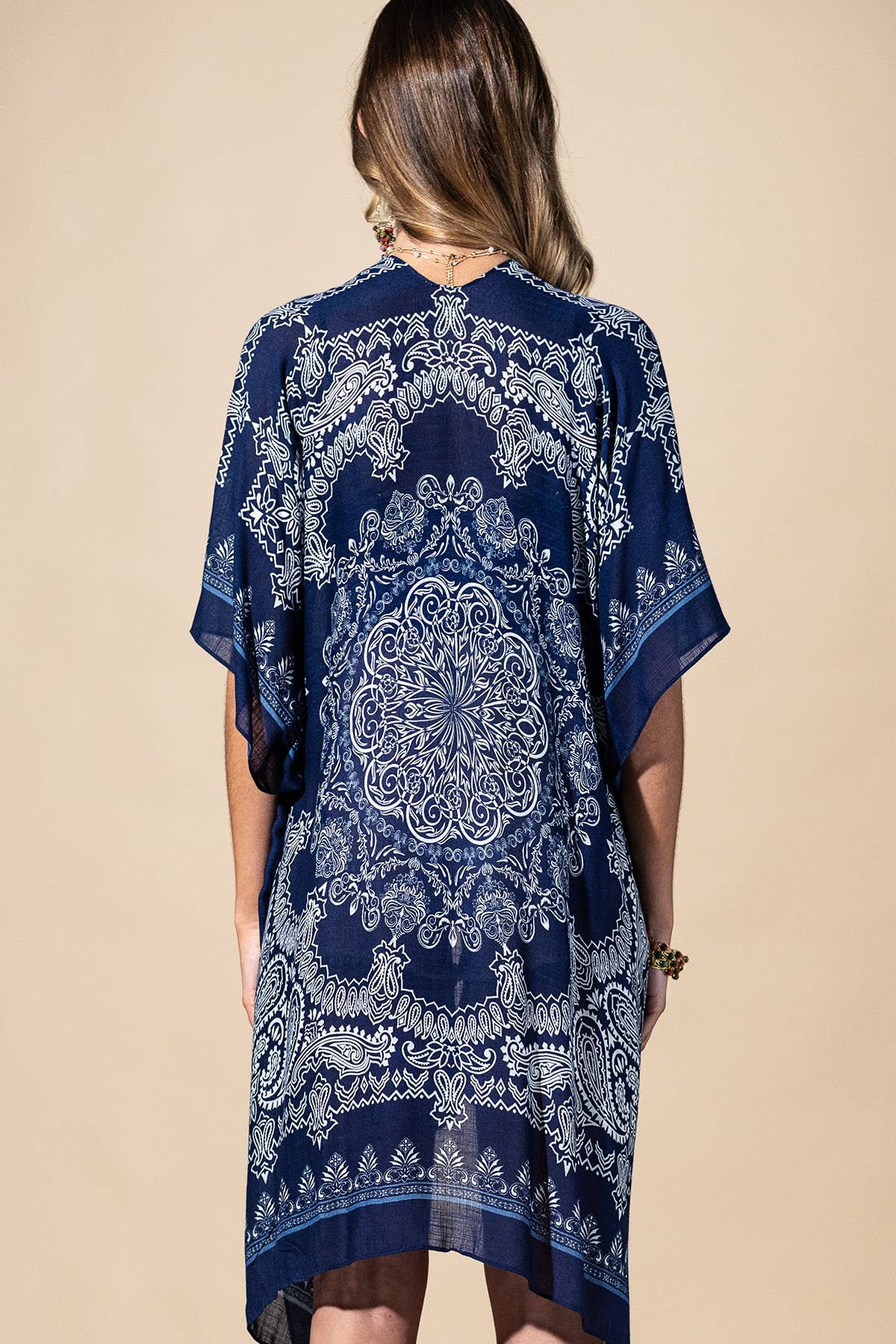 Navy blue patterned kimono-style garment on a beige background