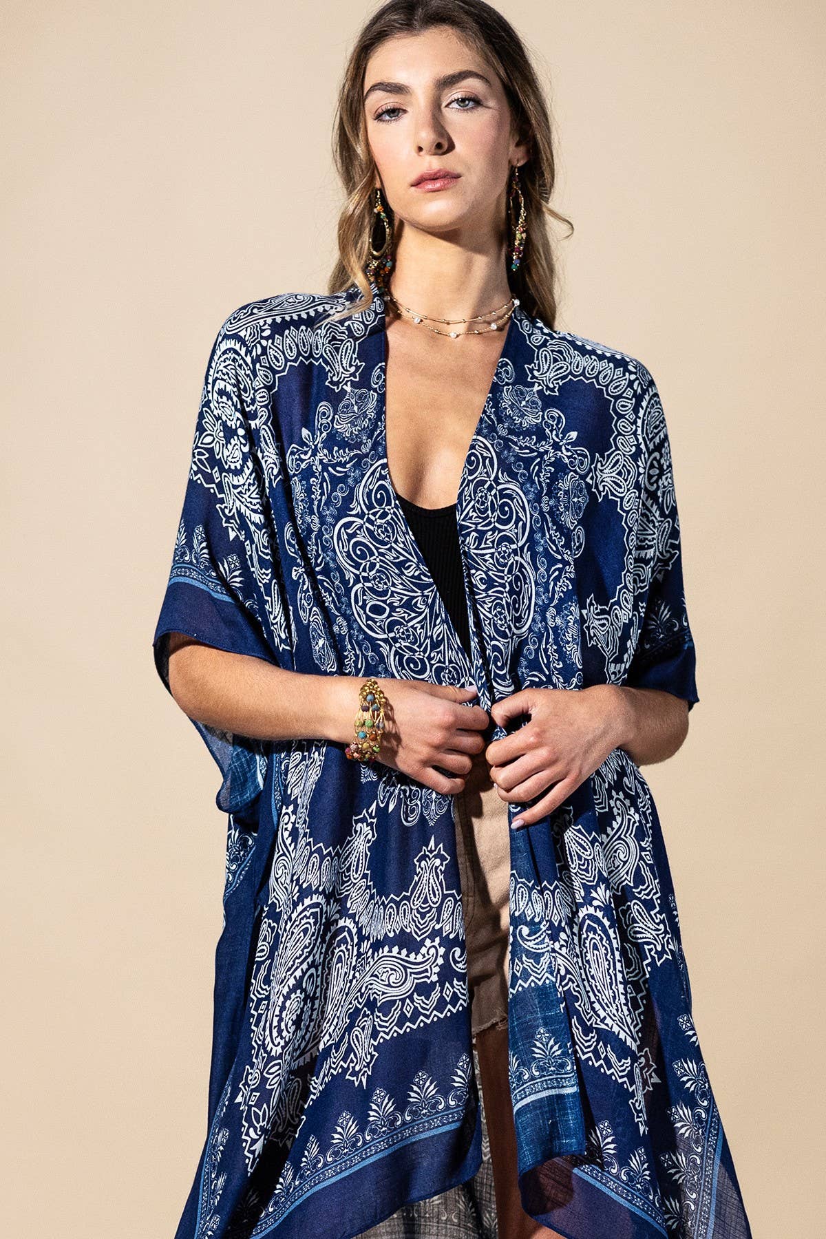 Woman wearing a blue patterned kimono against a beige background
