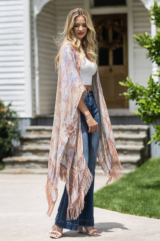 Woman wearing a floral kimono in front of a house