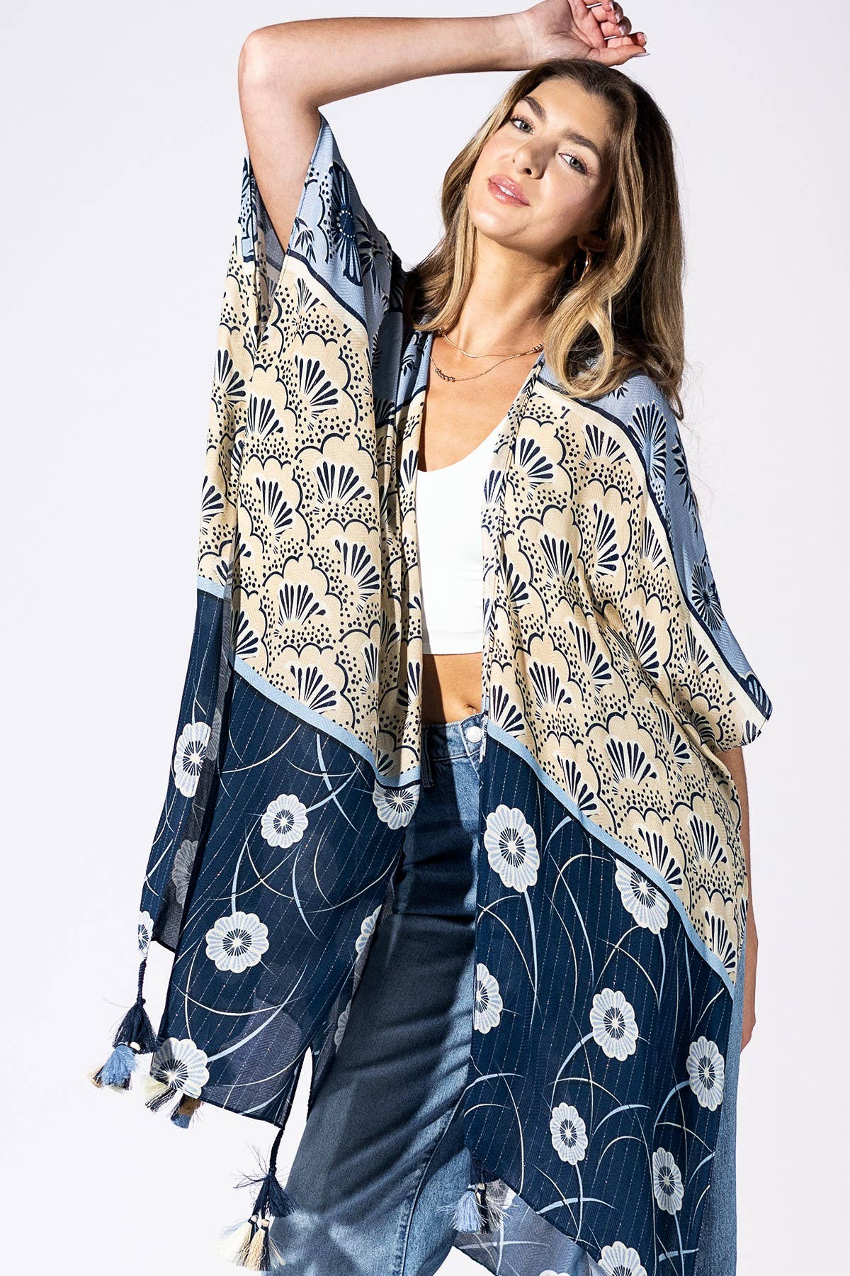 Woman wearing a floral kimono-style jacket on a white background