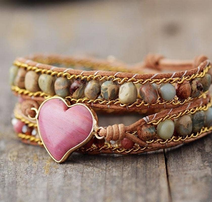 Multistrand bracelet with heart charm on a wooden surface, featuring Free Spirit Shop branding.